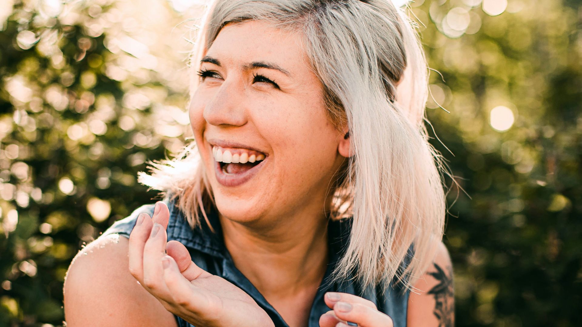 woman in black tank top smiling