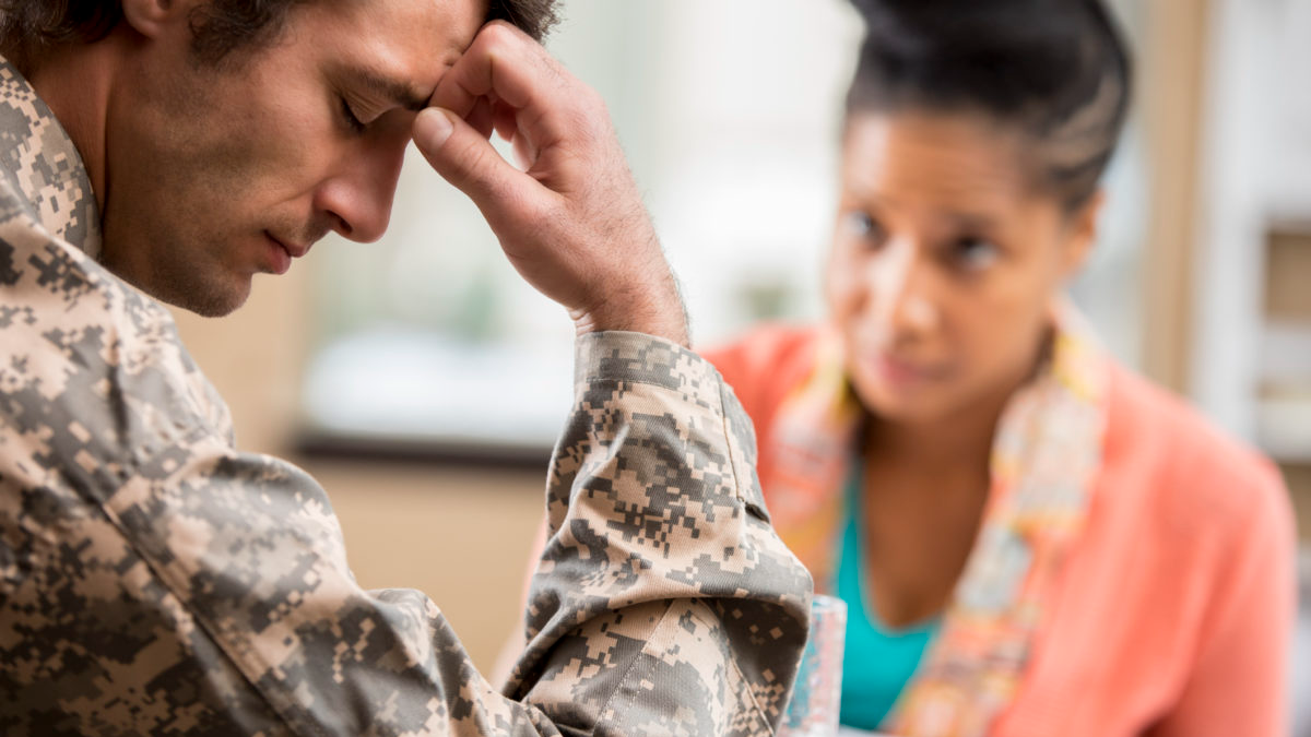 Depressed veteran meets with psychologist.