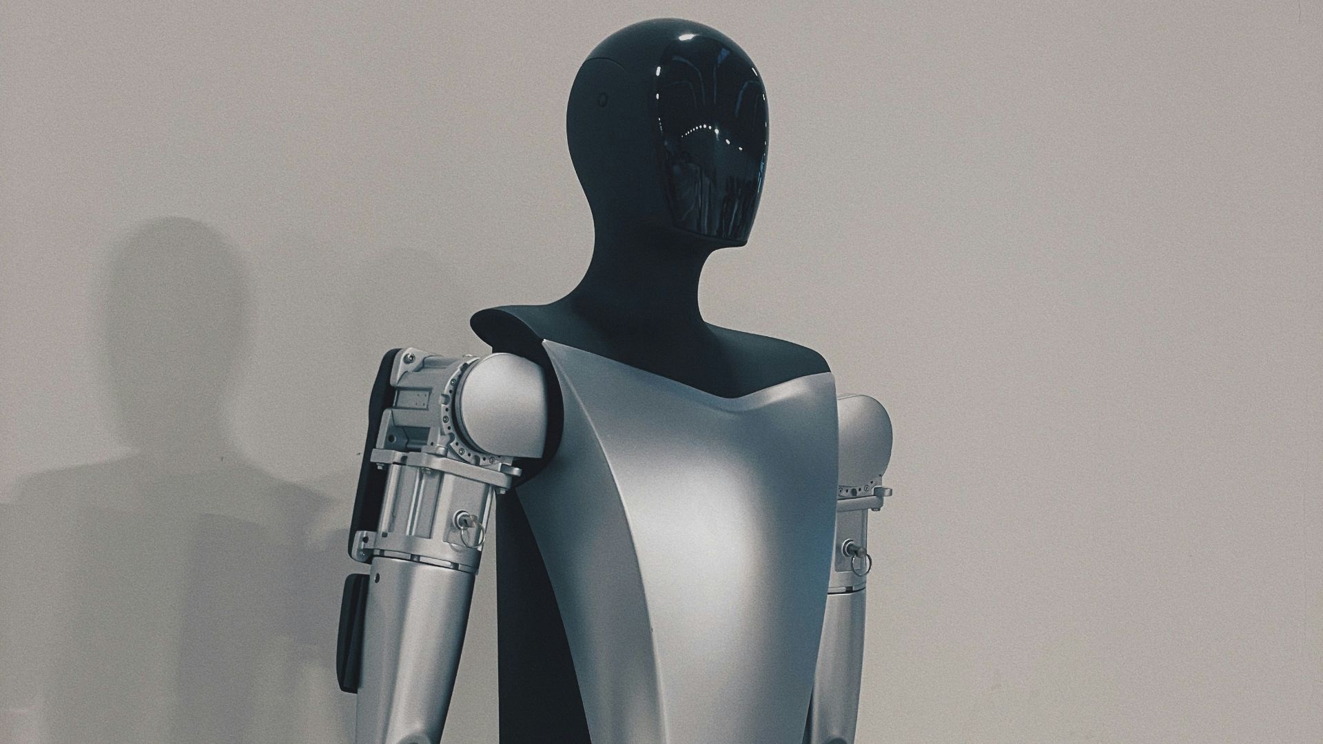 a robot standing in front of a white wall
