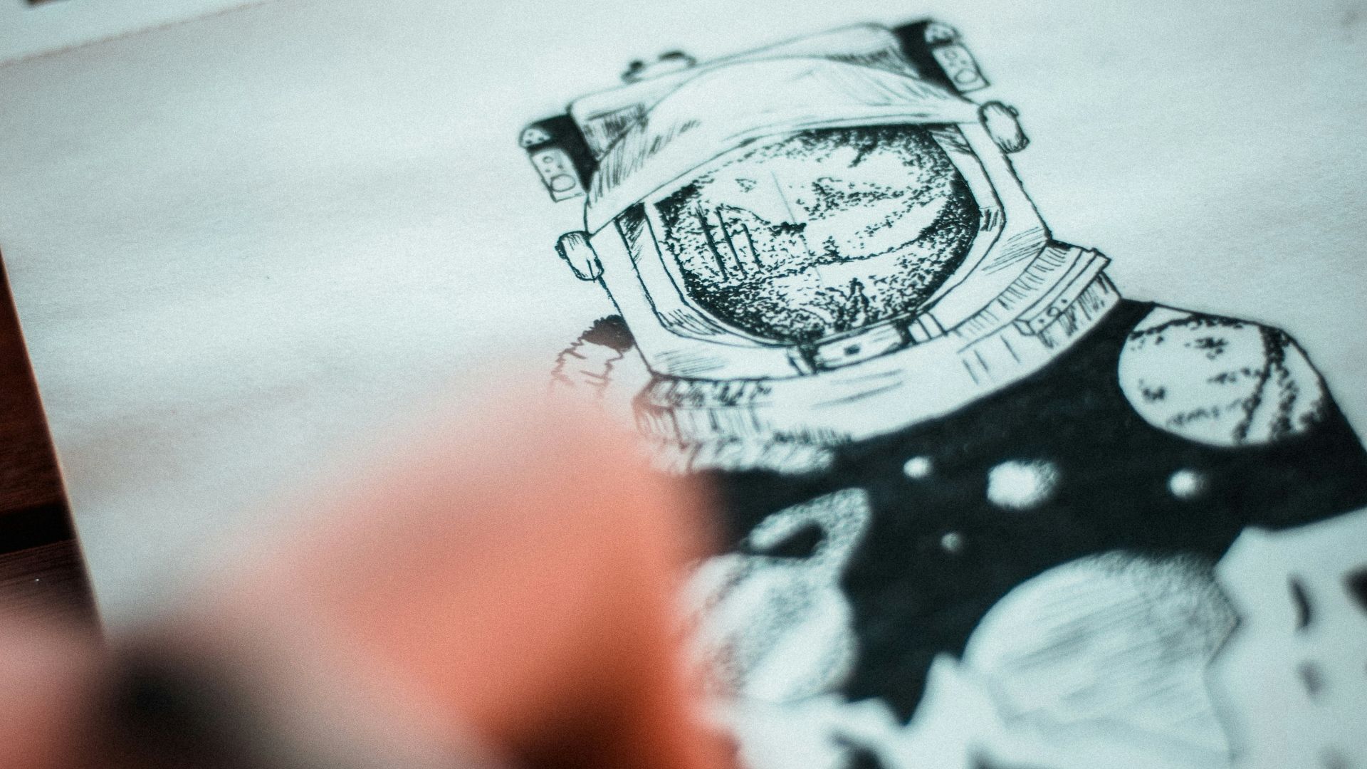 a person drawing a picture on a piece of paper