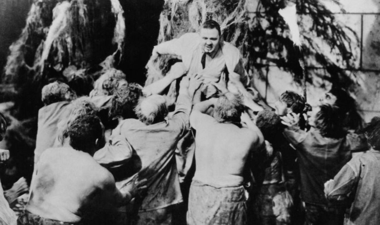 Charles Laughton is fighting away little people in a scene from the film 'The Island Of Lost Souls', 1932.