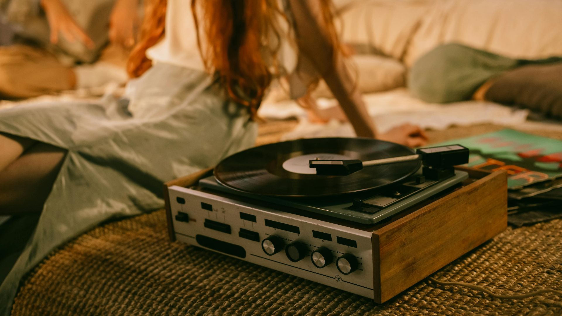 A cozy indoor scene featuring a vintage vinyl record player and a relaxed atmosphere.