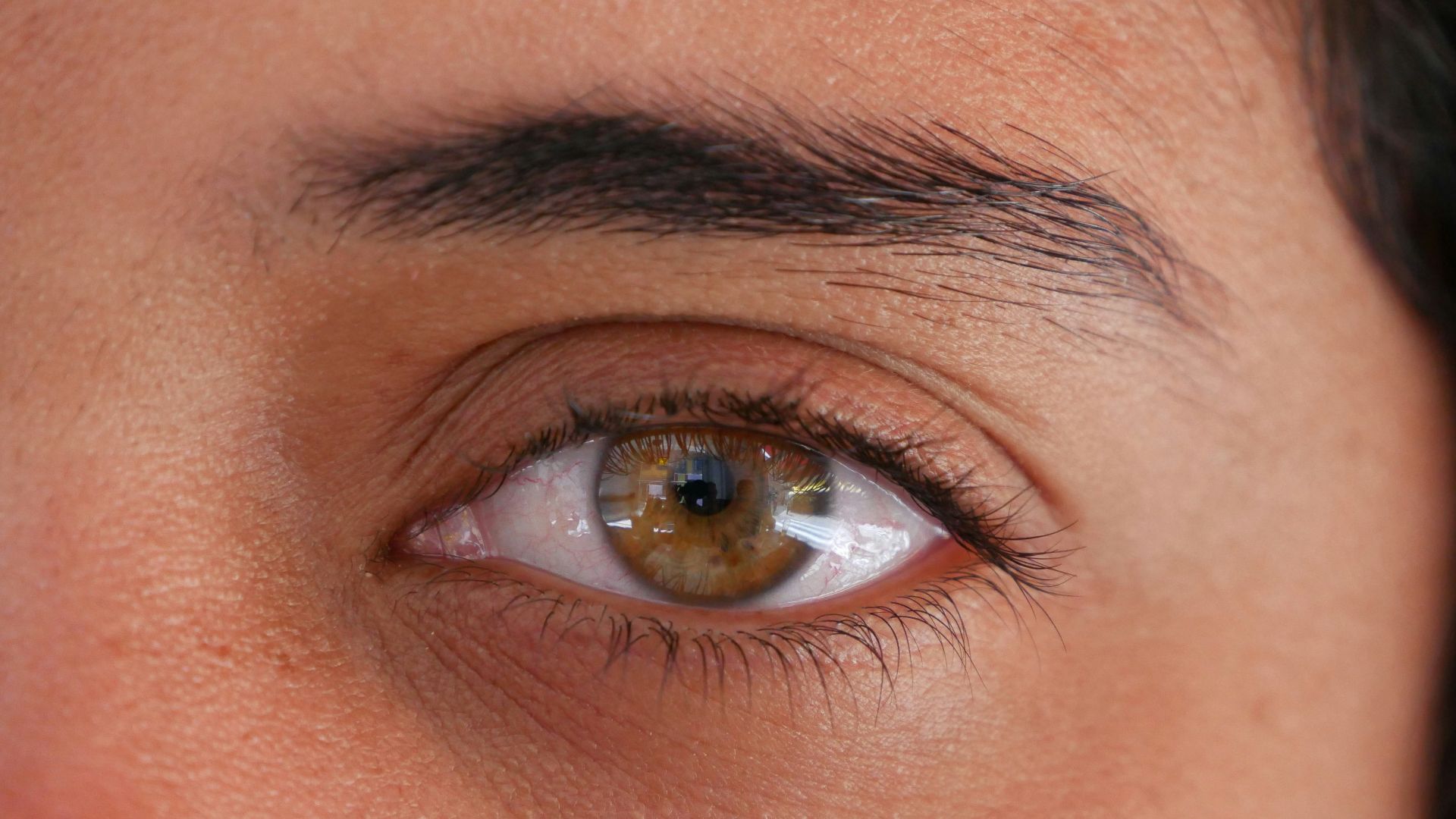 a close up of a person's brown eye