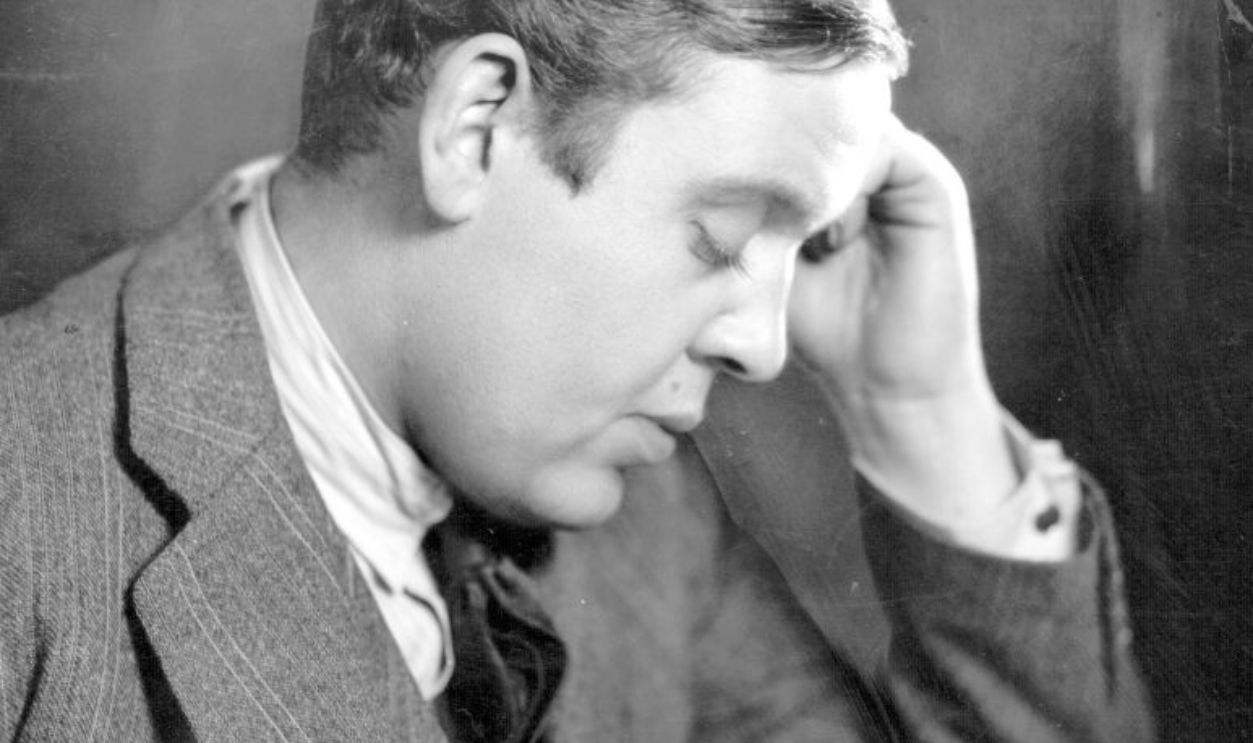 November 1928: British character actor Charles Laughton (1899 - 1962) sits at a desk reading for the part of 'Mr Pickwick' at the Haymarket Theatre.