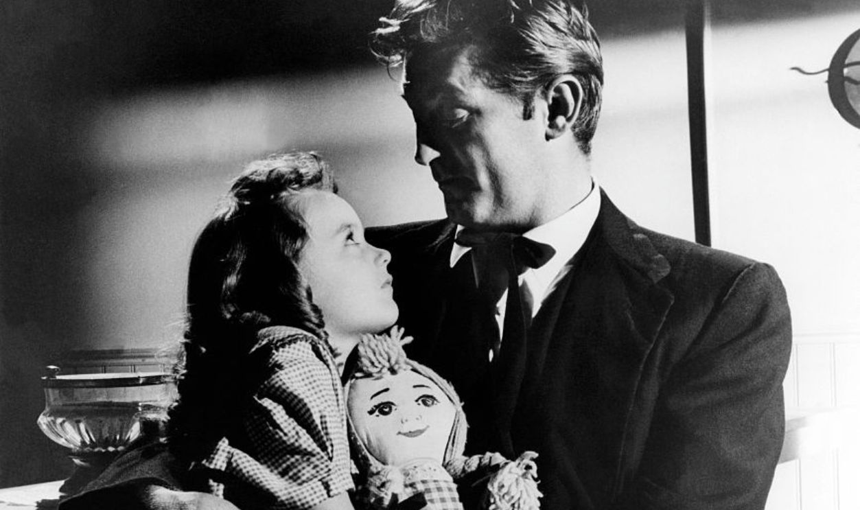 American actors Sally Jane Bruce and Robert Mitchum on the set of The Night of the Hunter, based on the novel by Davis Grubb and directed by Charles Laughton.