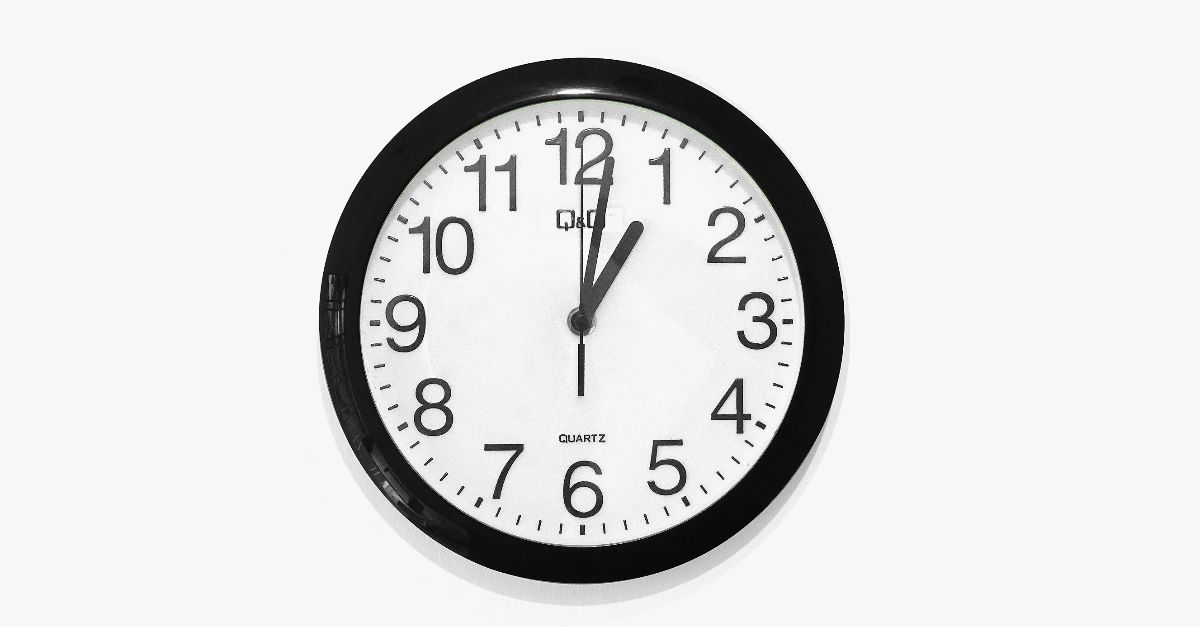 black and white round analog wall clock at 10 10