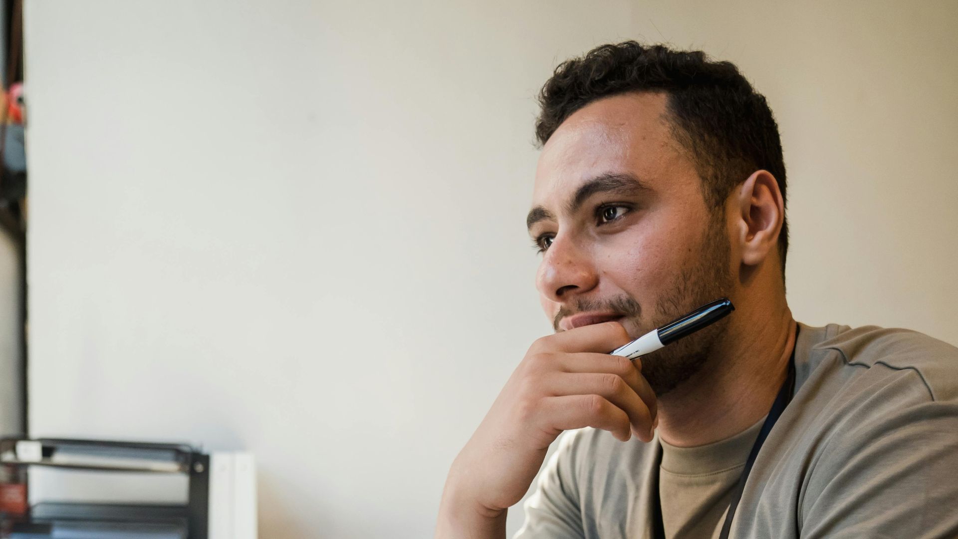 A man ponders ideas at his office desk, capturing a thoughtful moment.