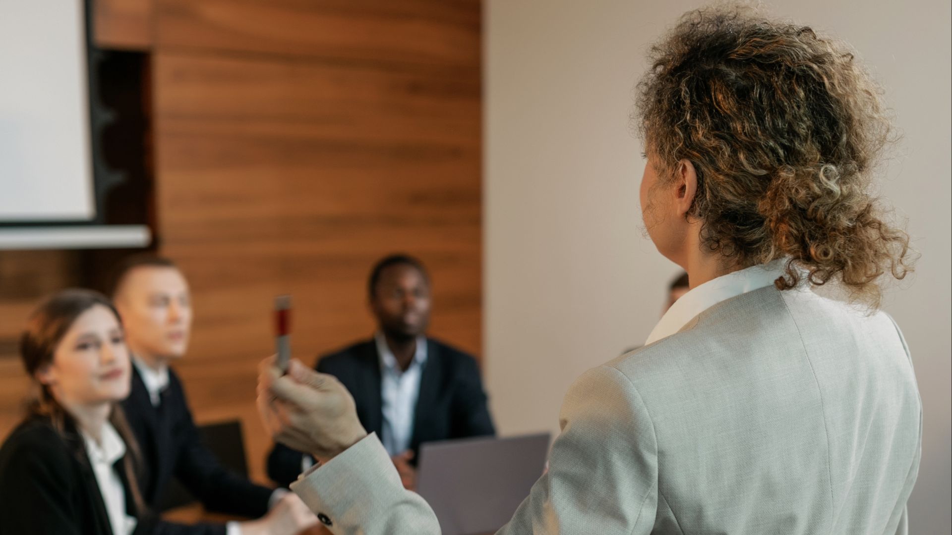 Business professionals in a meeting room discussing corporate strategies.