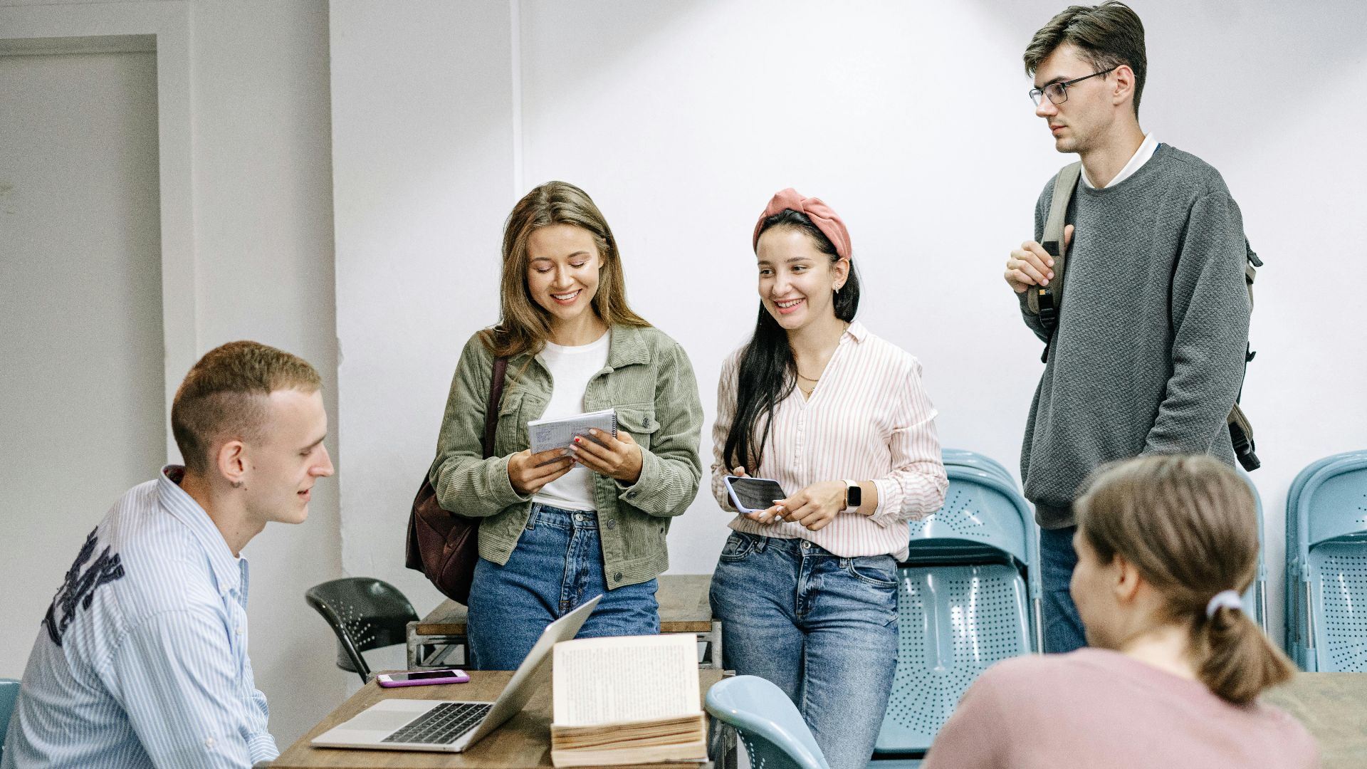 A diverse group of college students engaging in a lively study session indoors.