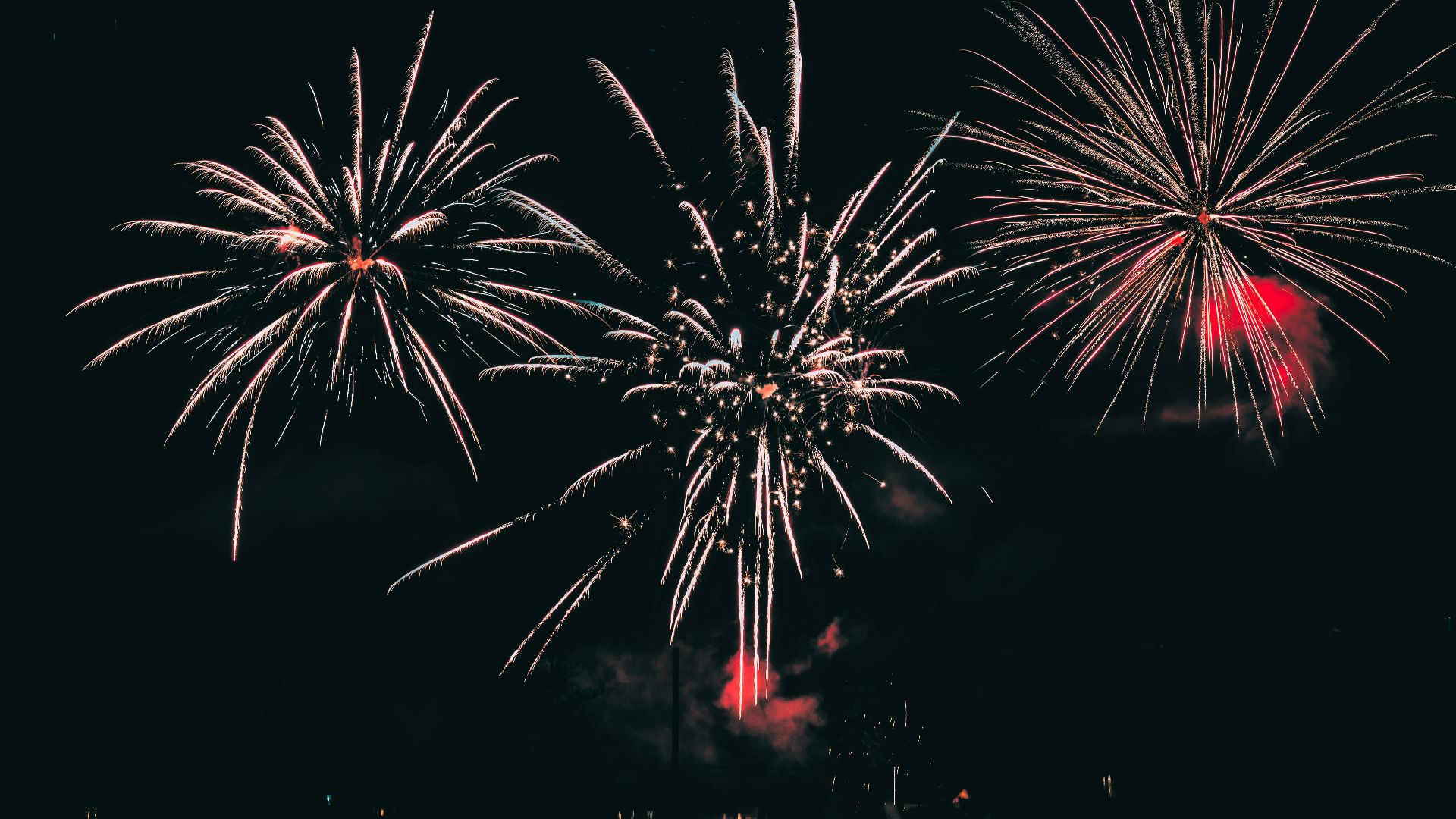 Vibrant fireworks illuminating the night sky with colorful bursts.