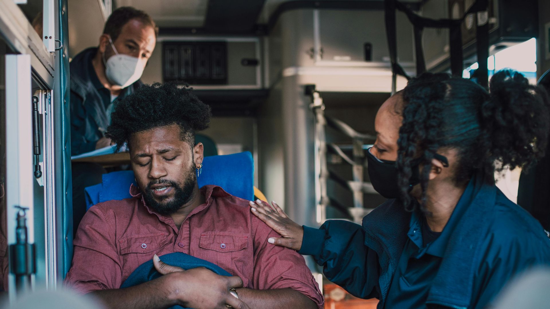 Paramedics provide emergency care to a patient inside an ambulance, ensuring timely medical attention.