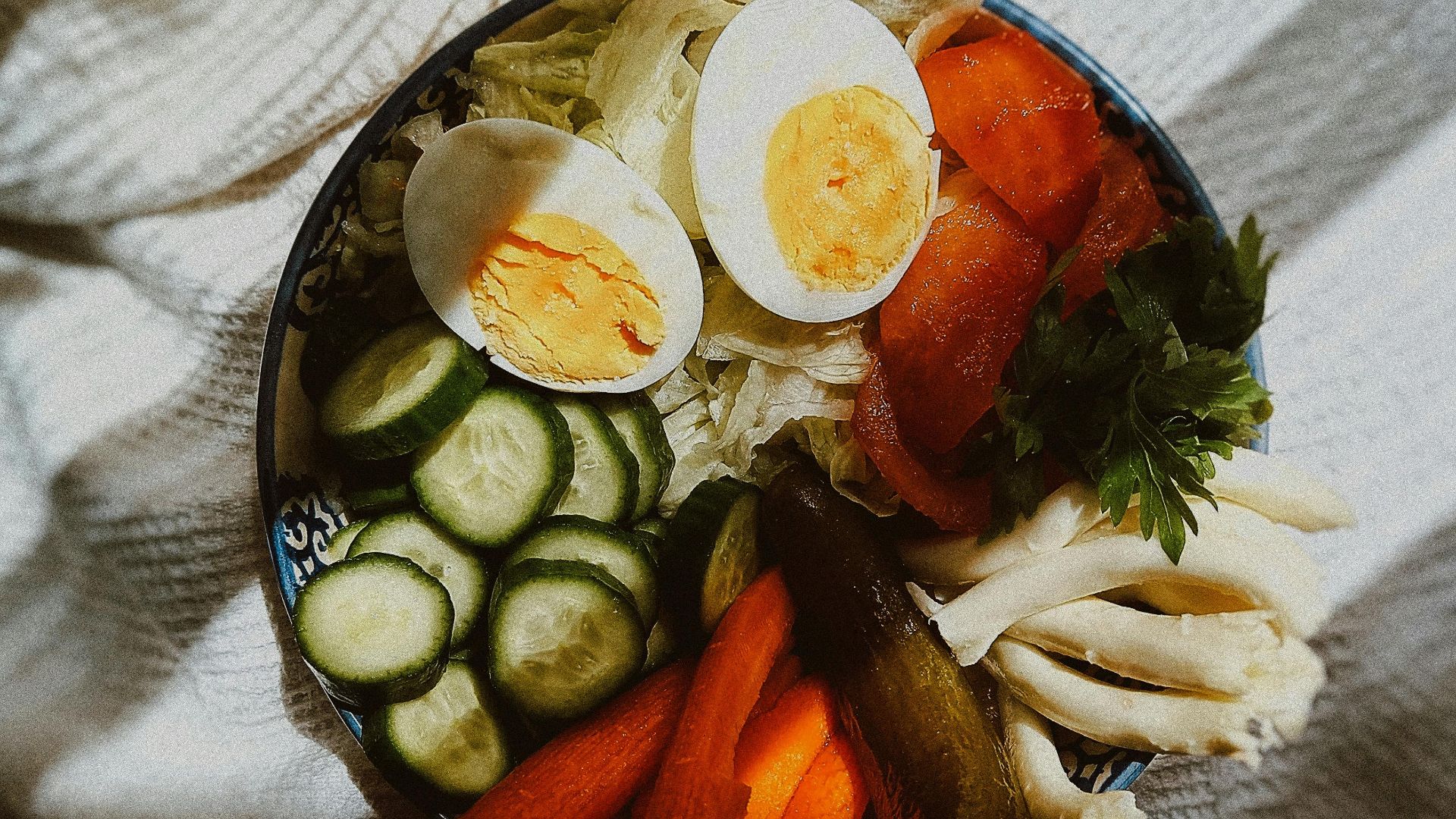 Vibrant platter featuring boiled eggs, fresh vegetables, and parsley, perfect for a healthy meal.