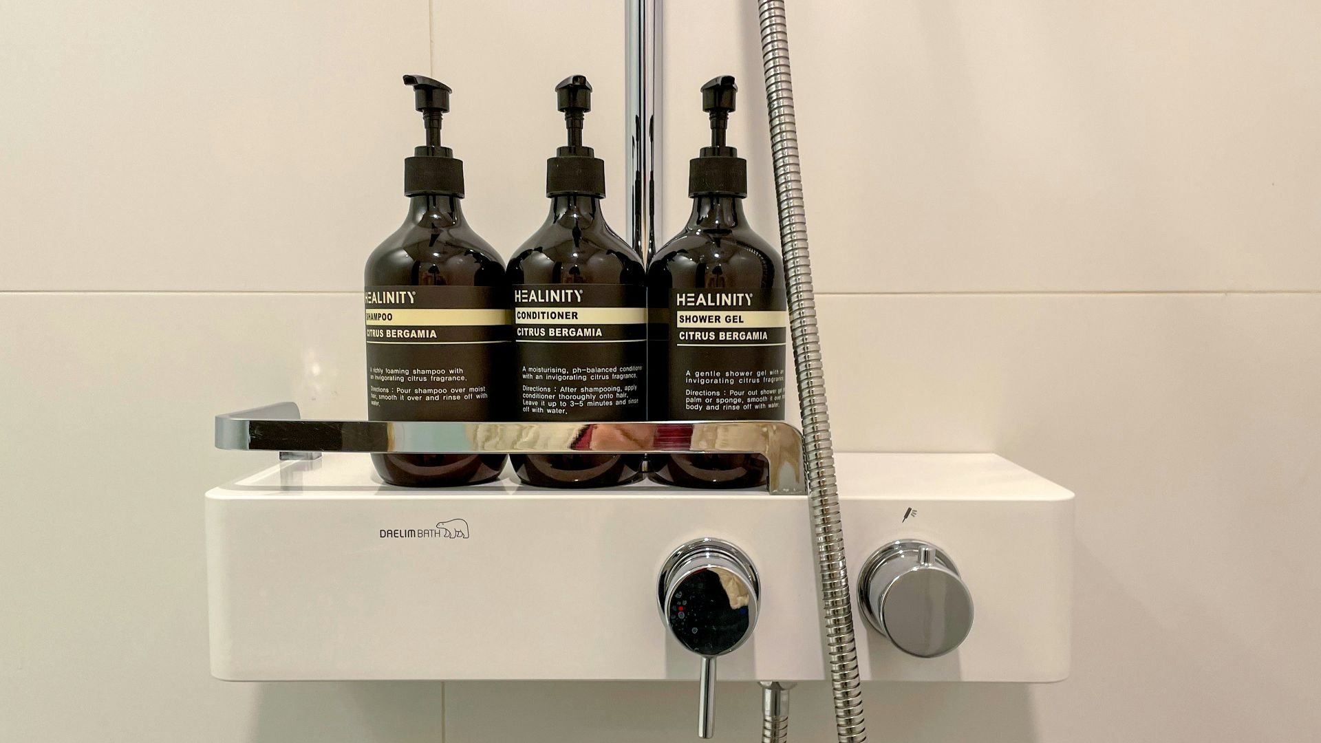three bottles of shampoo sitting on top of a sink