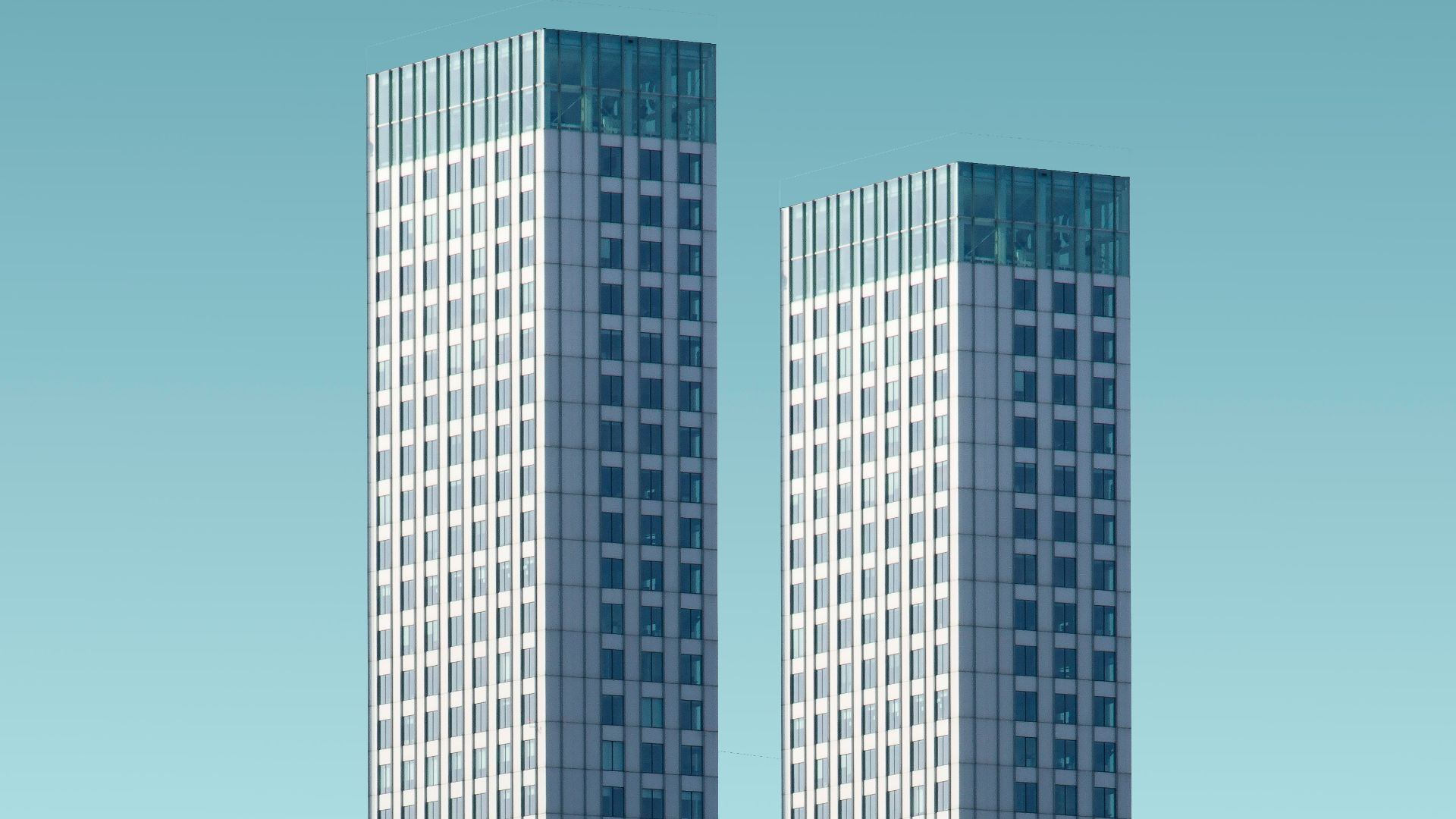 two teal-and-white skyscrapers