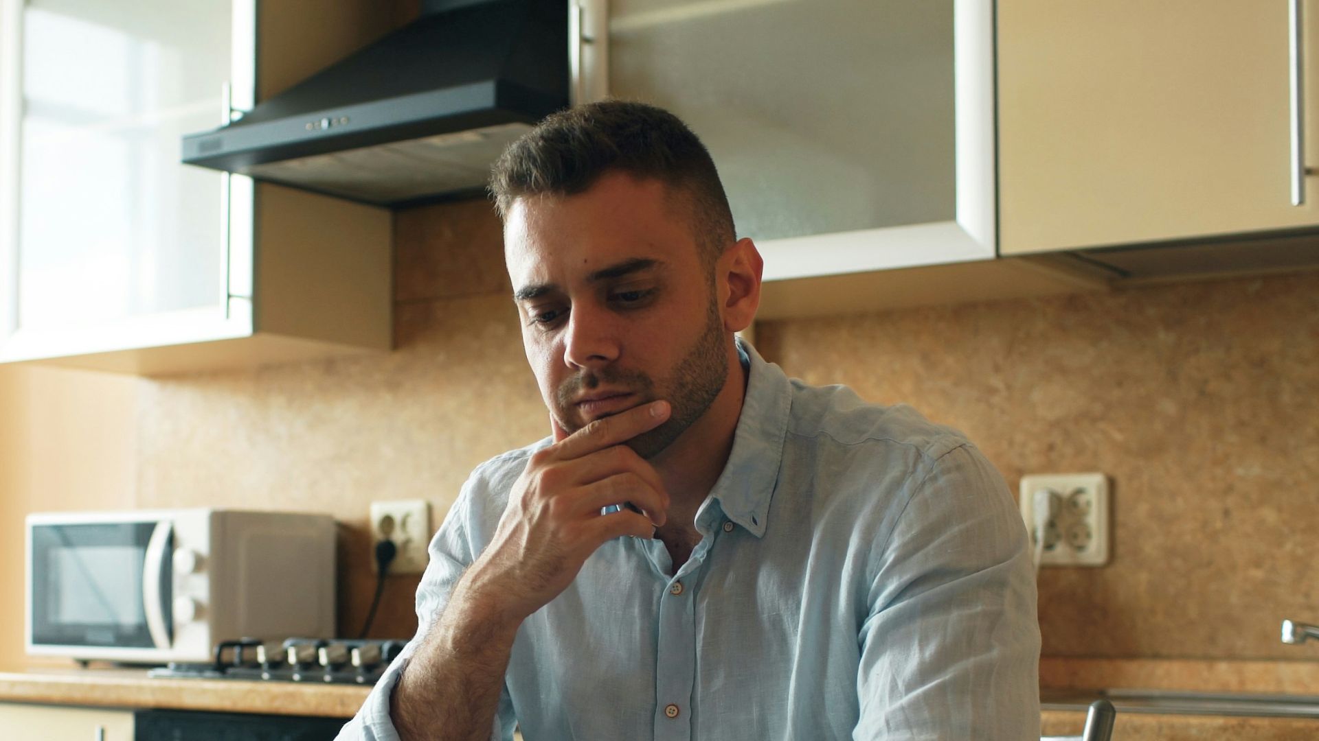 Man reading a document in a kitchen