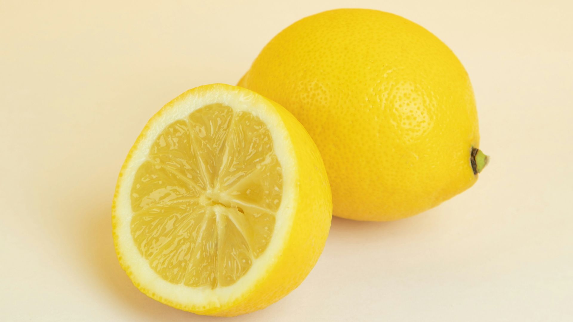 yellow lemon fruit on white surface
