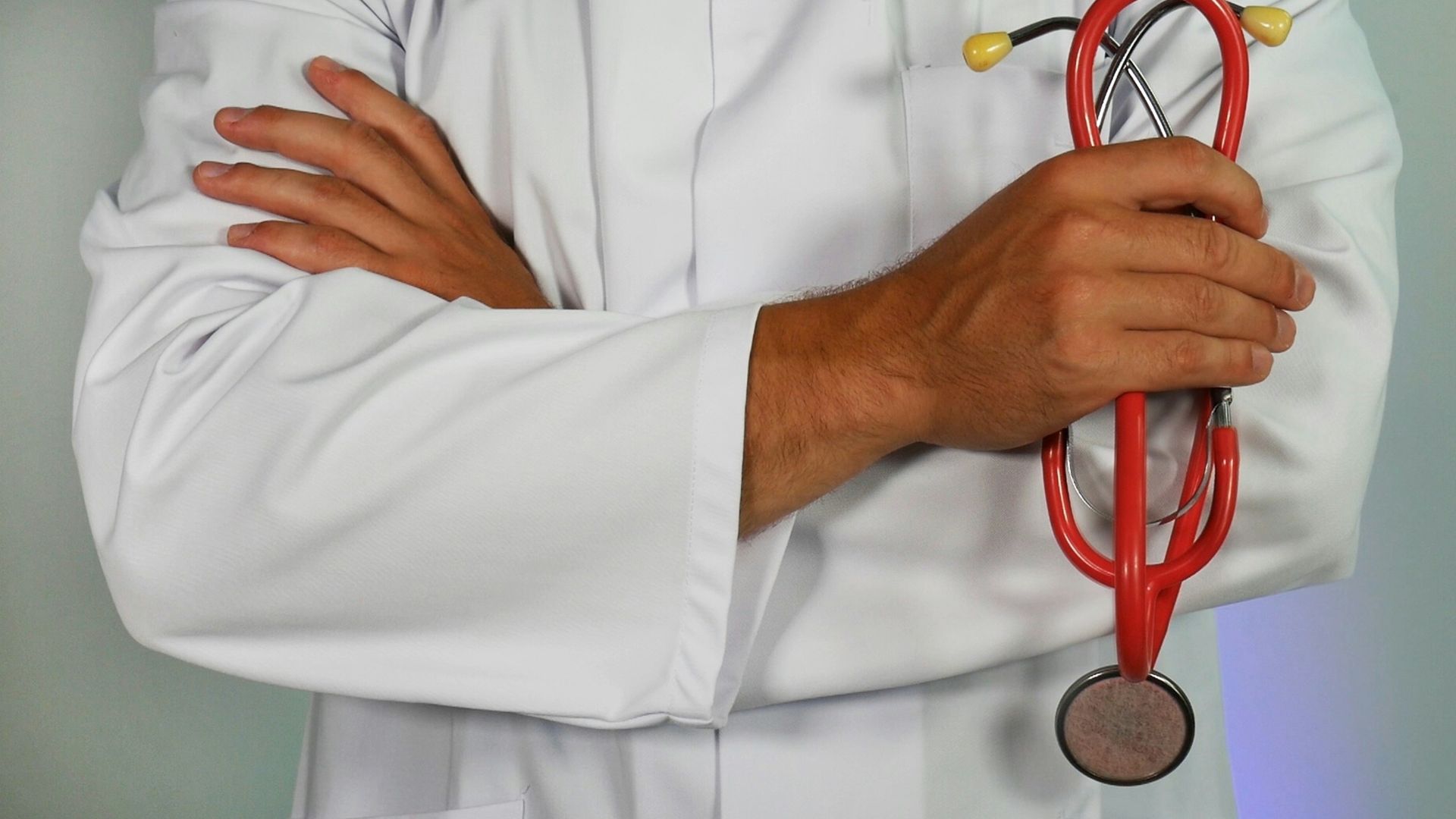 doctor holding red stethoscope