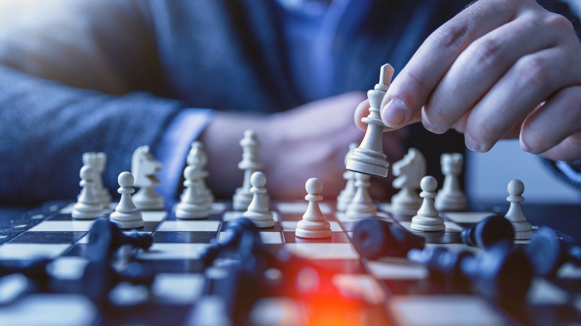 depth of field photography of man playing chess