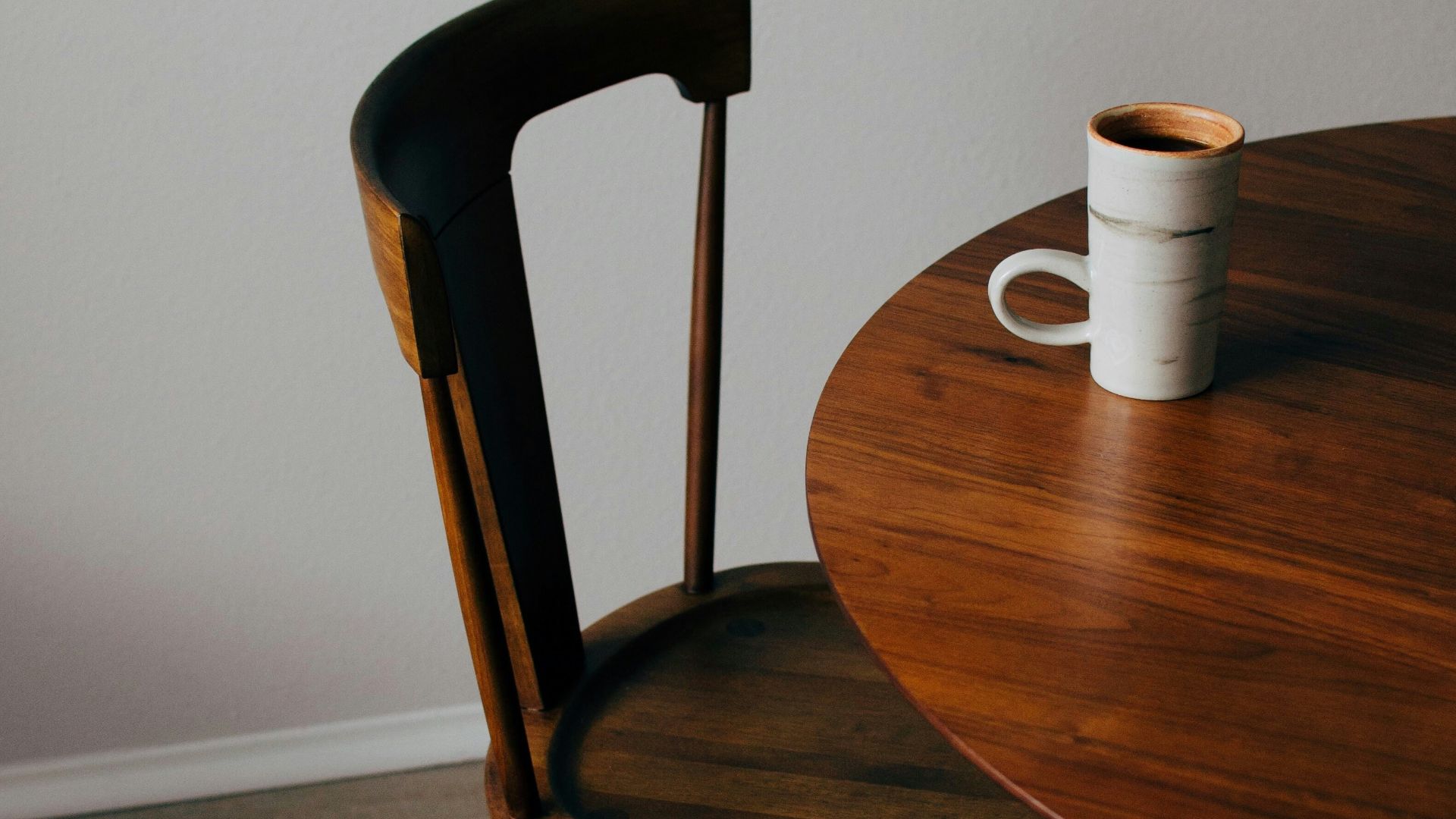 white ceramic mug on brown wooden table