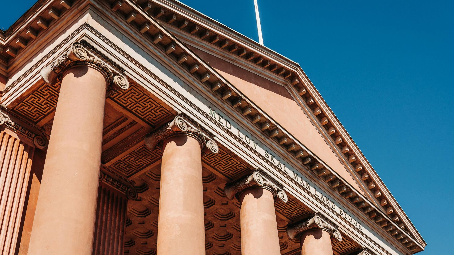 Low angle view of Københavns Byret showcasing its neoclassical colonnade.