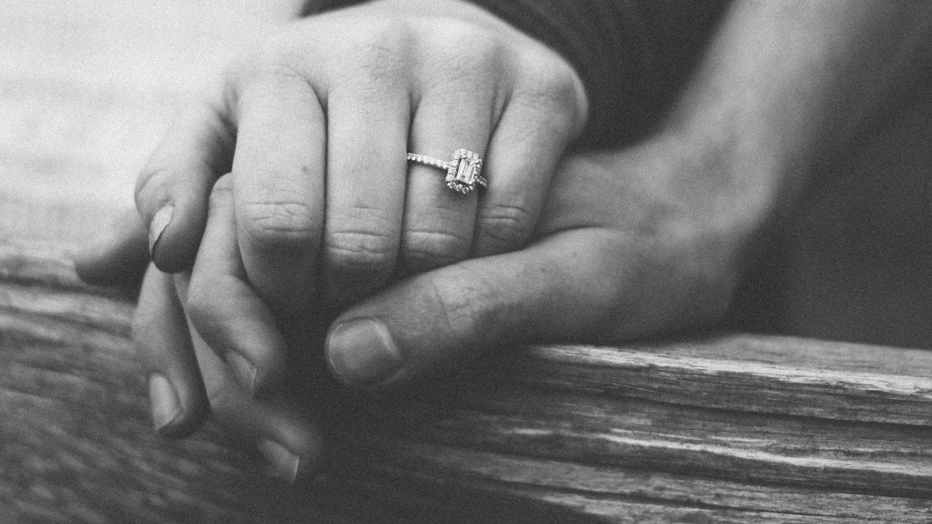 a couple holding hands with a wedding ring visible