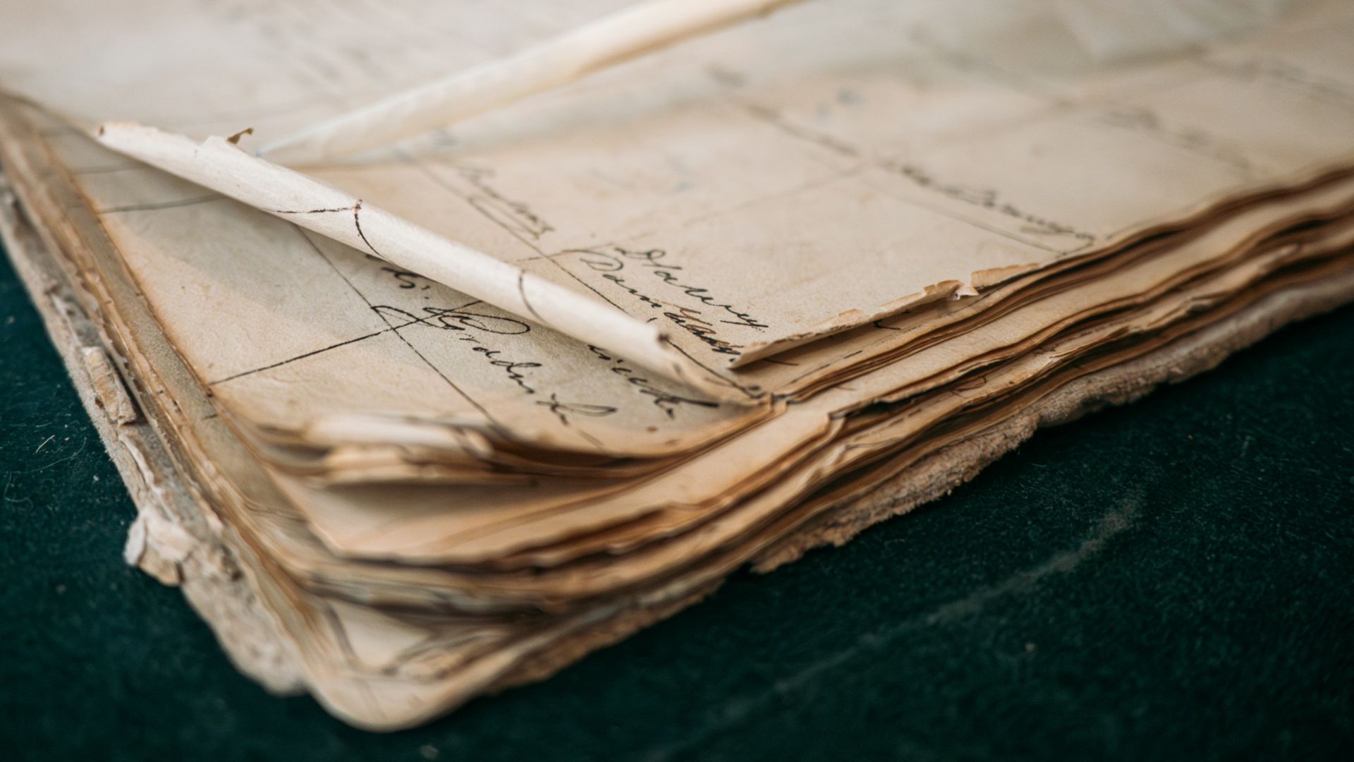 A close-up of an old, open ledger with handwritten notes.