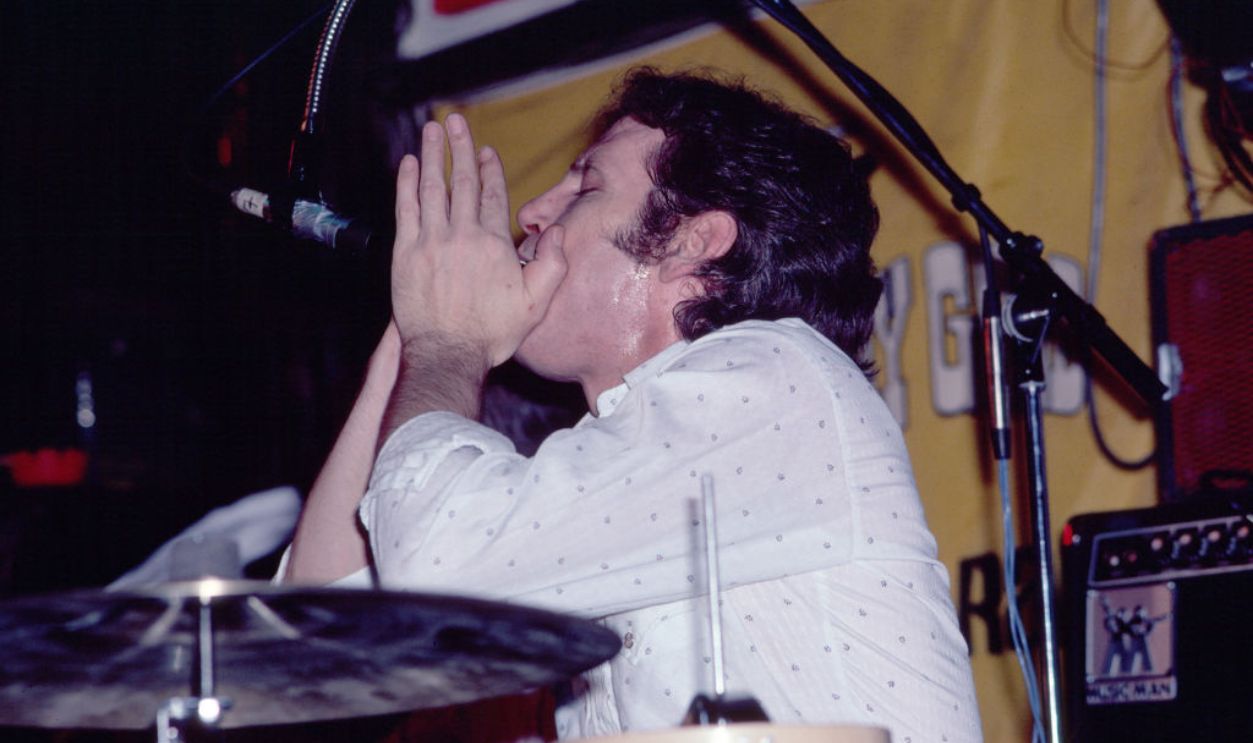 American Rock musician Levon Helm (1940 - 2012) plays harmonica as he performs onstage at the Lone Star Cafe, New York, New York, February 17, 1981. 