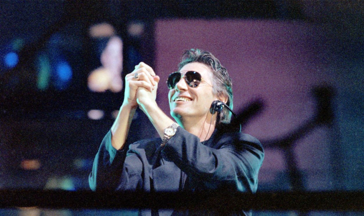 FILED - 21 July 1990, Berlin: Roger Waters, ex-bassist of the British bombastic rockers Pink Floyd, stretches his praying hands towards the sky. Shortly after the fall of the Wall, Roger Waters stages the Pink Floyd success 
