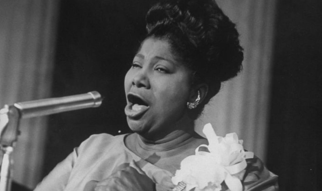 Singer Mahalia Jackson singing at reception in hotel.