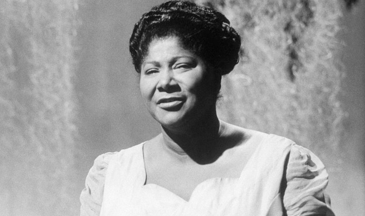 (Original Caption) Mahalia Jackson, Gospel Singer, waist up, smiling, hands folded.