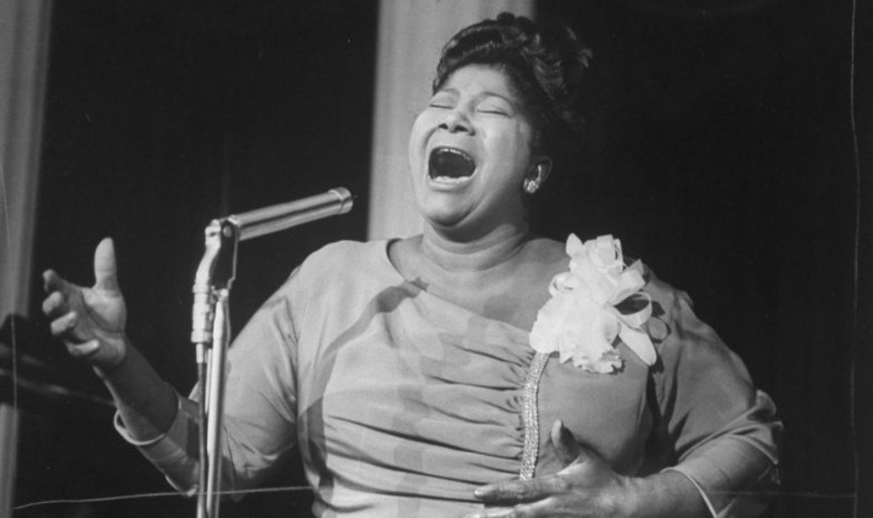 Singer Mahalia Jackson singing at reception in hotel.
