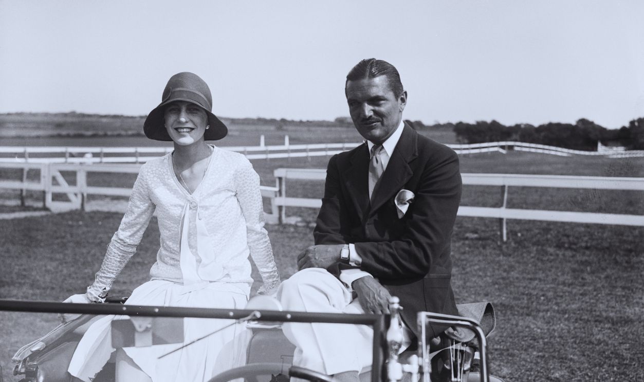 Gettyimages - 514690074, Couple Seated Atop Car (Original Caption) 8/17/1929-East Hampton, L.I., NY: Mr and mrs. J. Vernon Bouvier 3d, enjoying a convinient view of the fifth annual show of the Easthampton Riding Club, from the roof of their motor. 