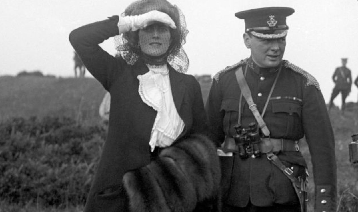 The Home Secretary Winston Churchill (centre) with his wife Clementine and General Bruce Hamilton watching Army maneuvers at Aldershot.