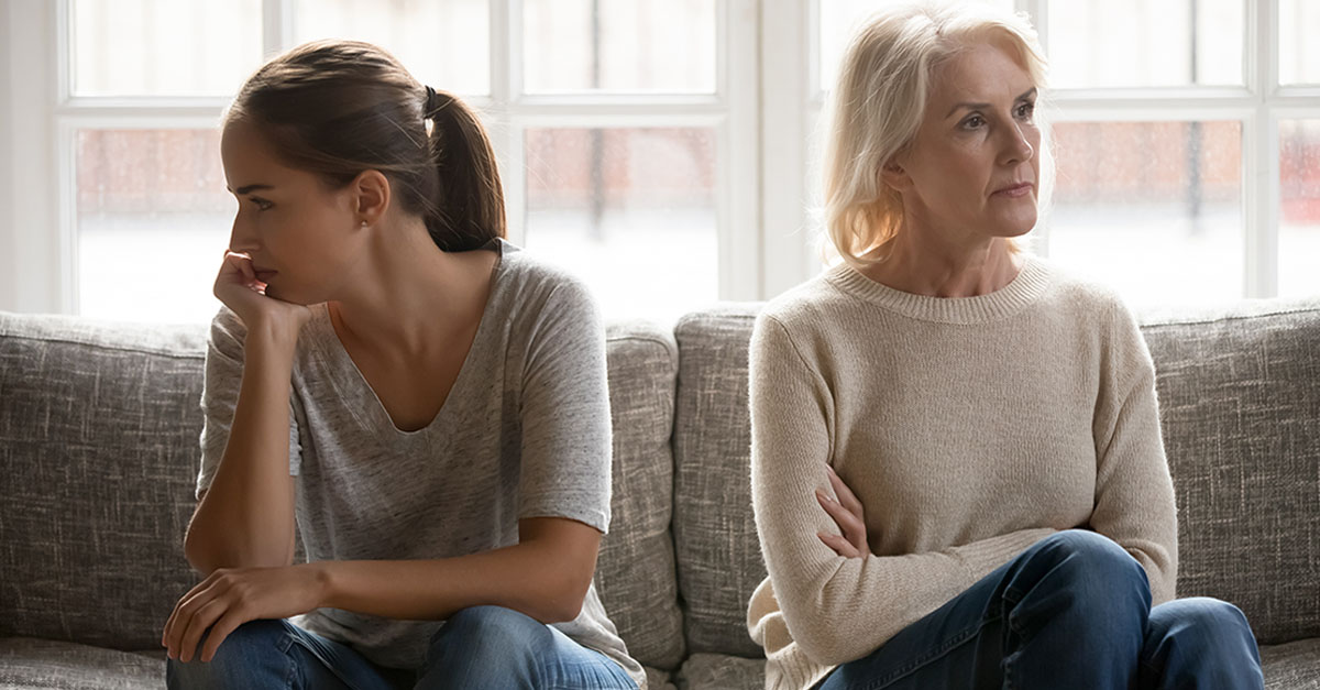 In quarrel elderly mother grown up daughter sit on couch