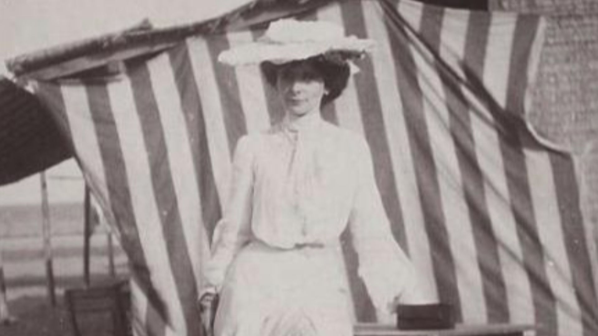 Woman in white before striped Canopy on Beach 1900s (Olga de Meyer ?)