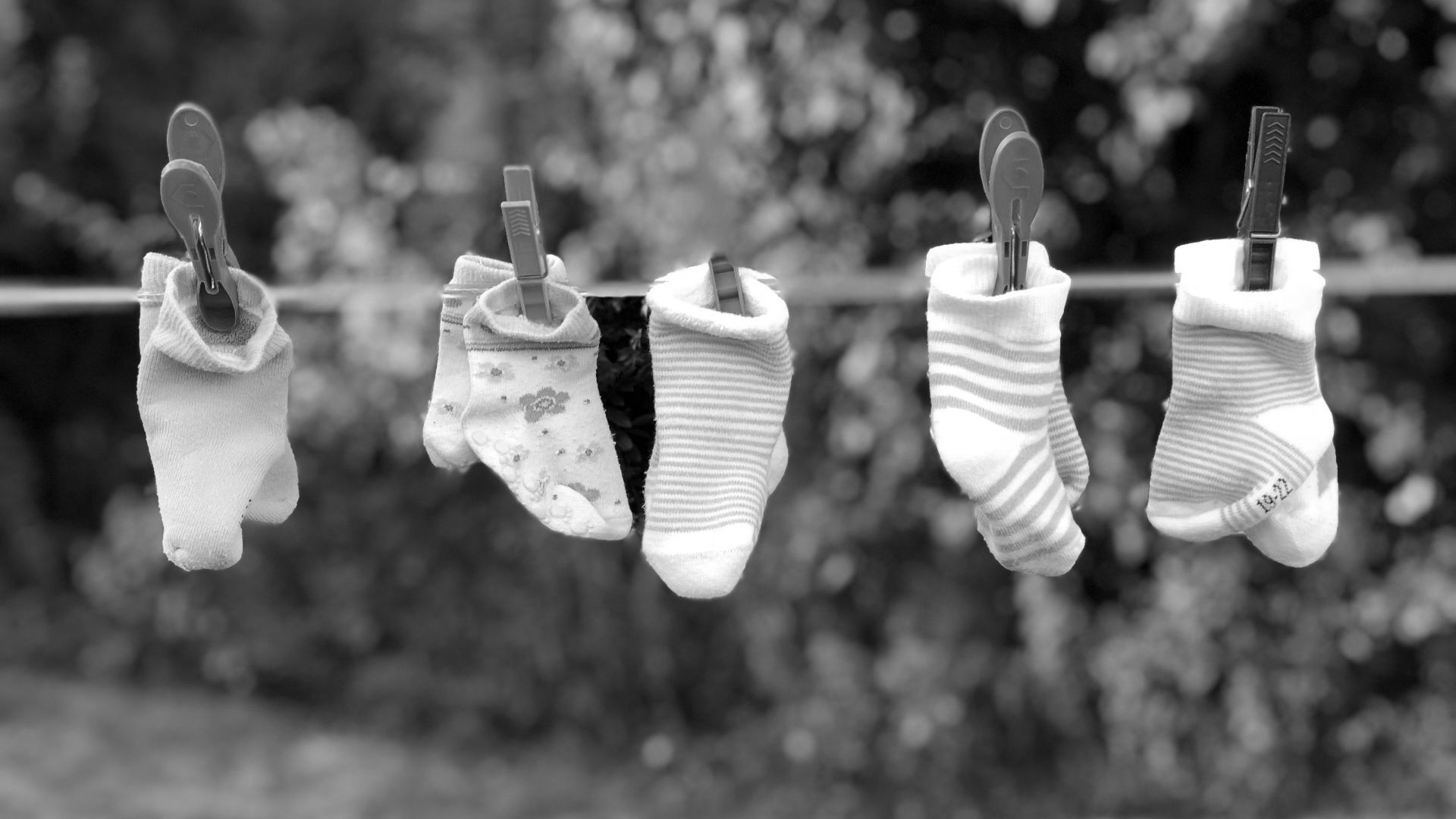 five pairs of socks pinned on clothesline