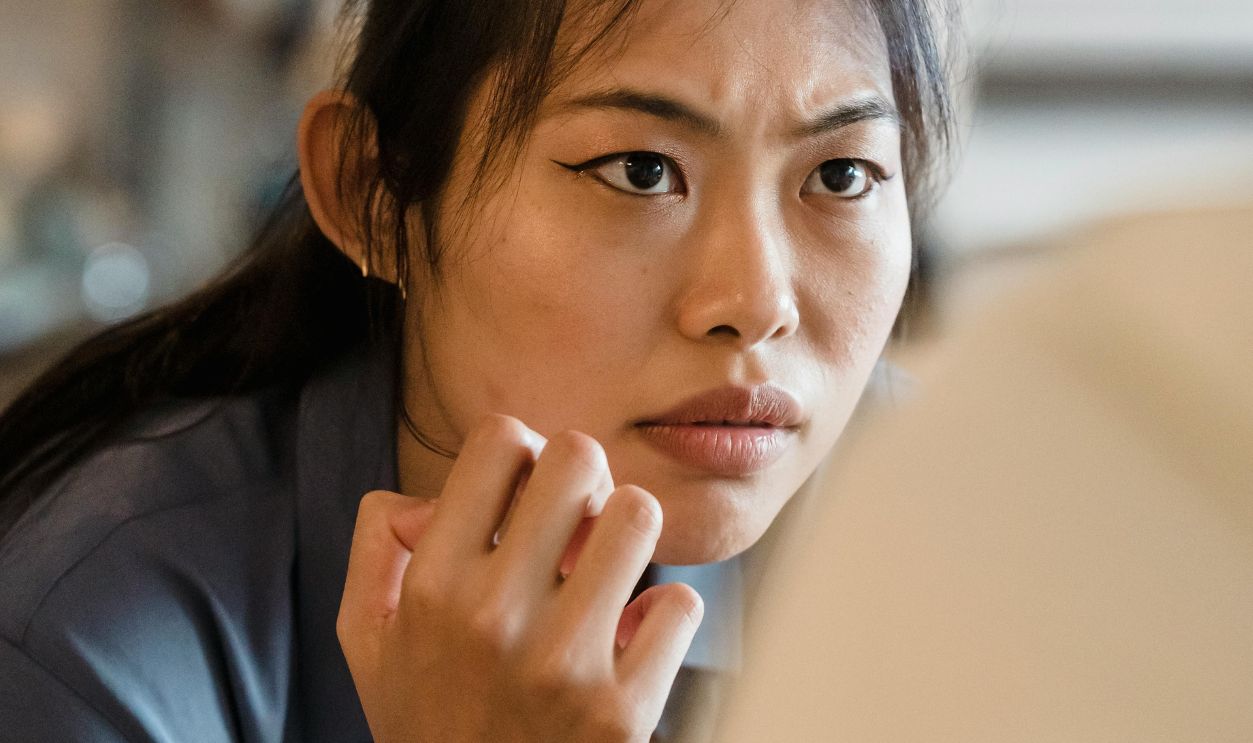Close-up of a woman indoors showing intense emotion, conveying concentration and determination