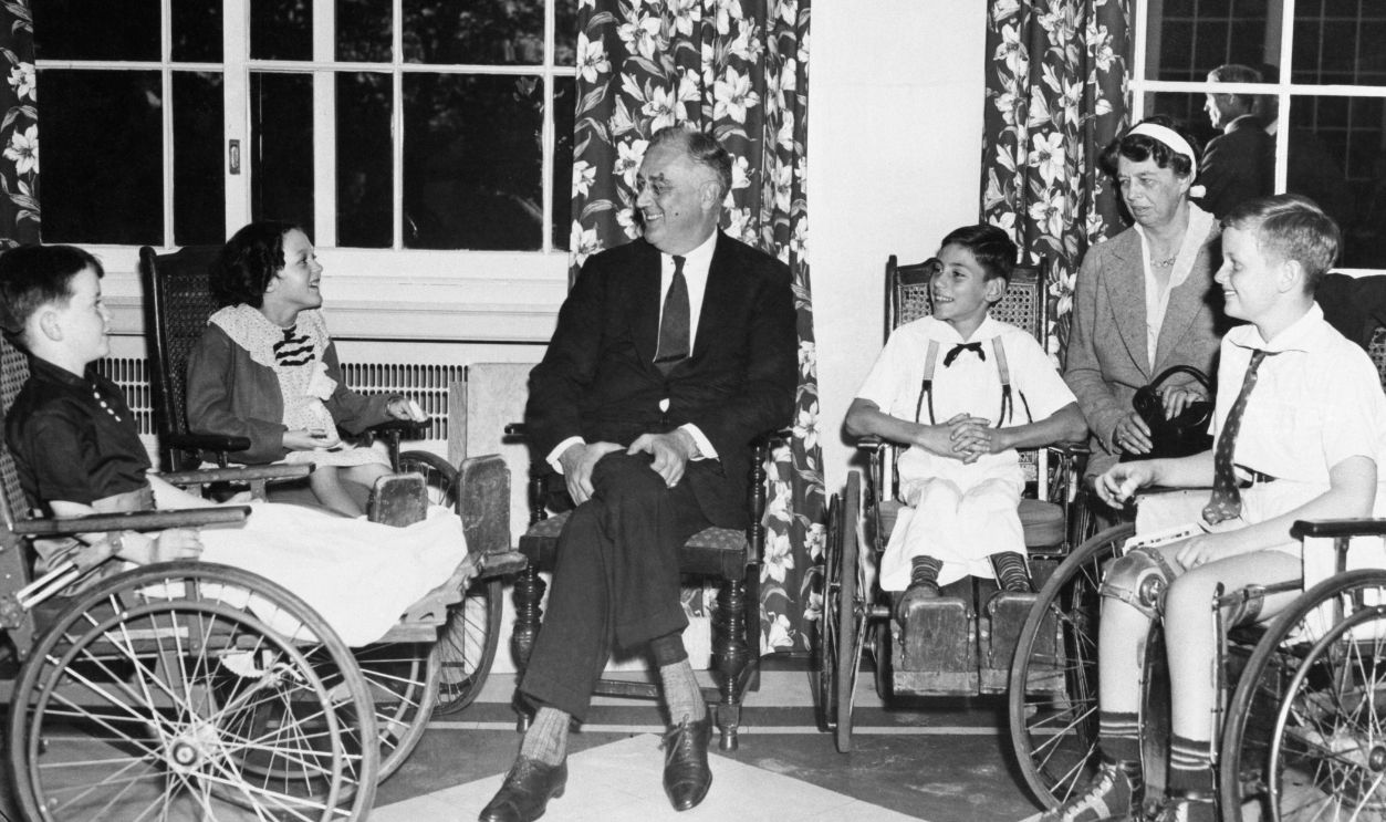 President and Mrs. Roosevelt enjoying after-luncheon conversation with little patients of the Warm Springs Foundation.