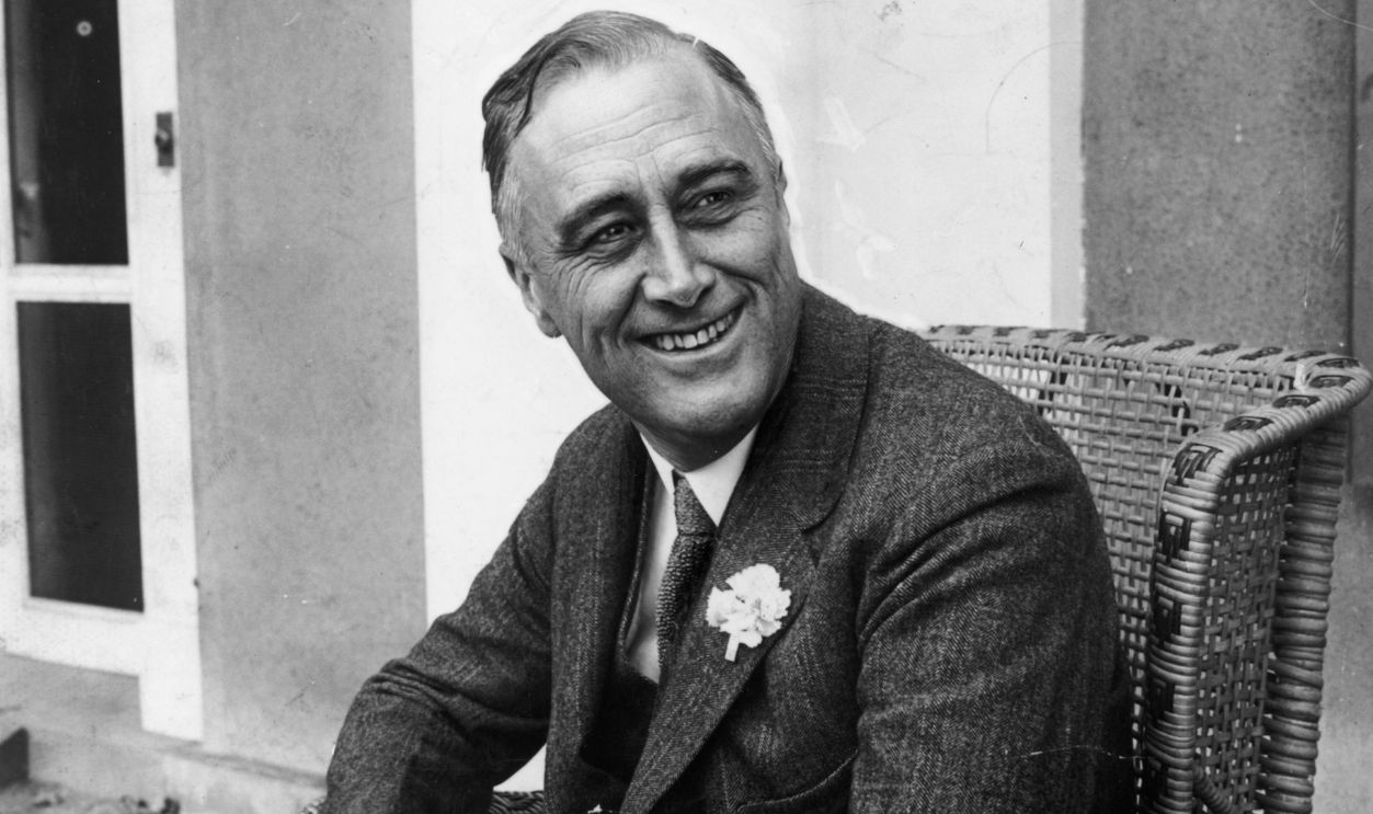  American statesman Franklin Delano Roosevelt (1882 - 1945) smiling when he heard that he was leading the contest for Governor of New York State. He later became the 32nd President of the USA. 