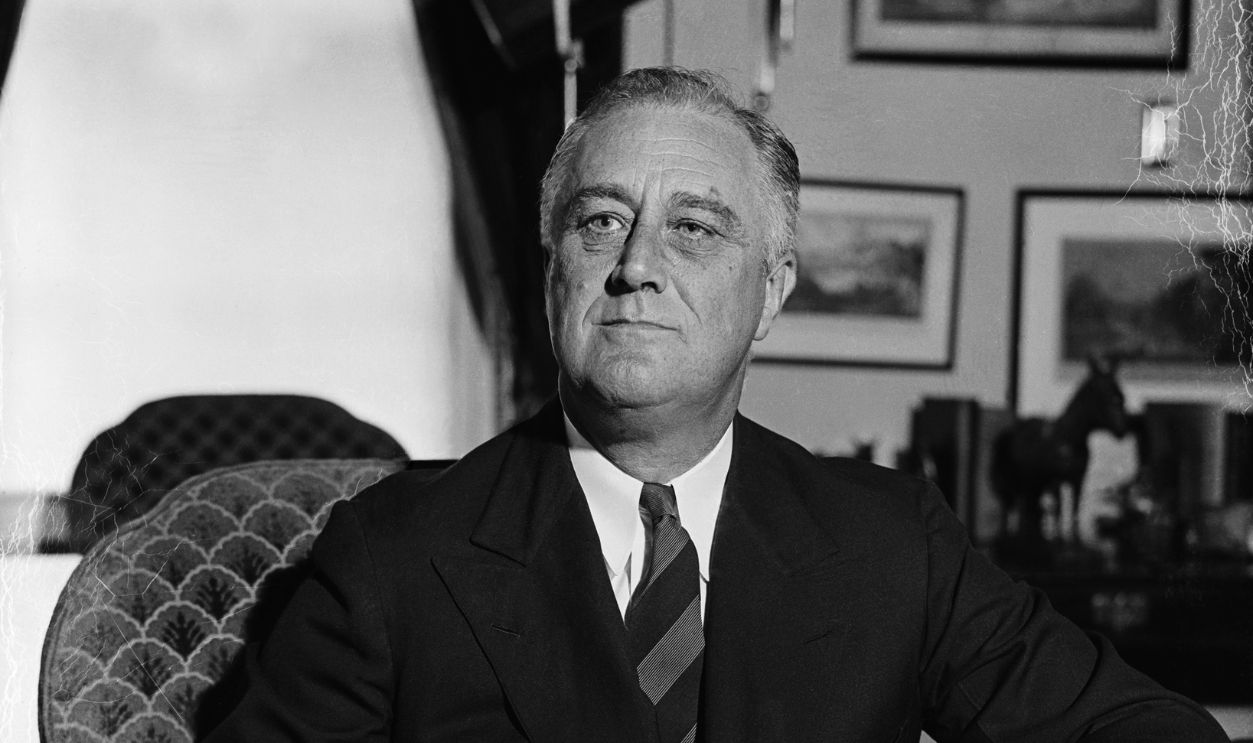 U.S. President Franklin Delano Roosevelt sitting at his desk in the Oval Office.