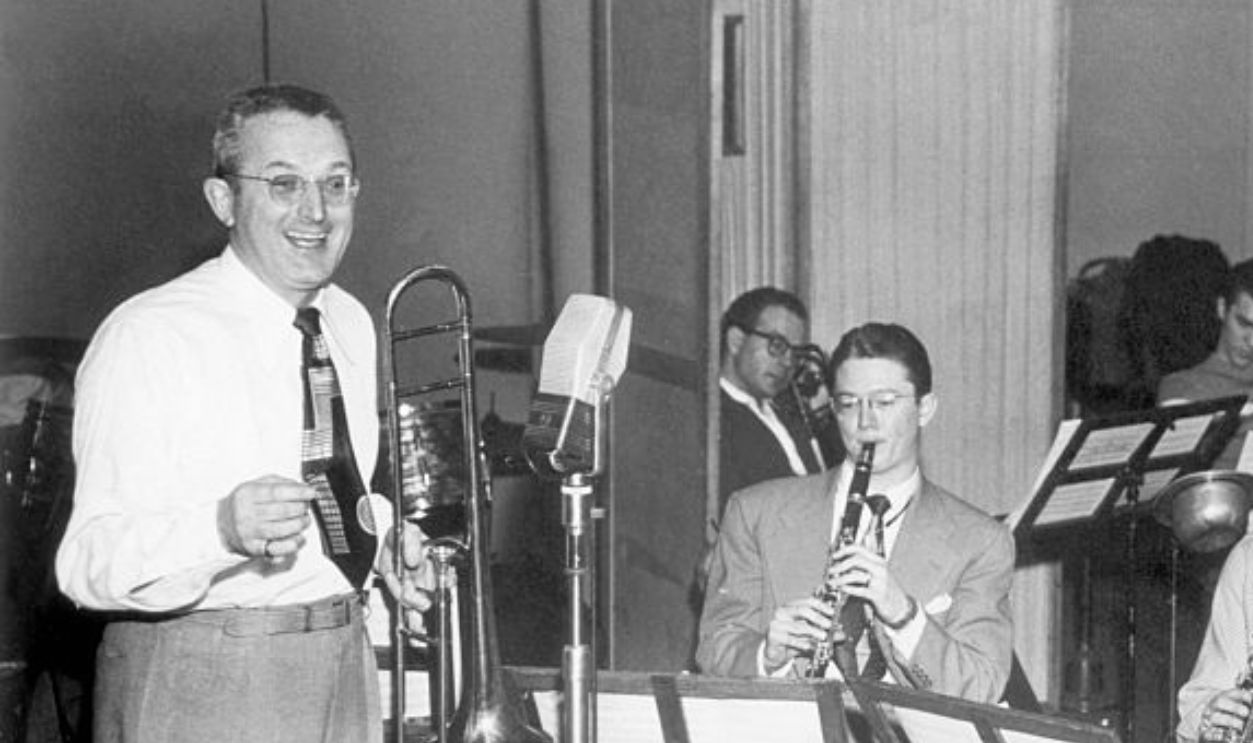 (Original Caption) dorsey; tommy big band leader, Tommy Dorsey, holding a saxophone during a rehearsal with his band. Undated photo circa 1940s.