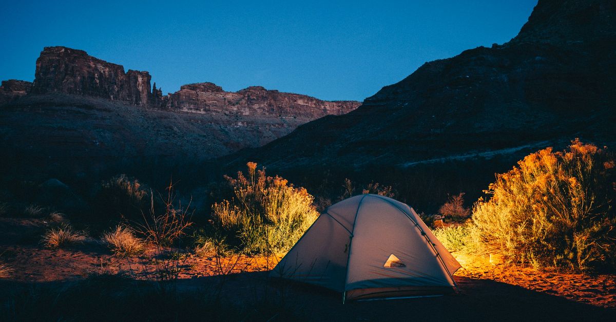 white camping tent beside mountain