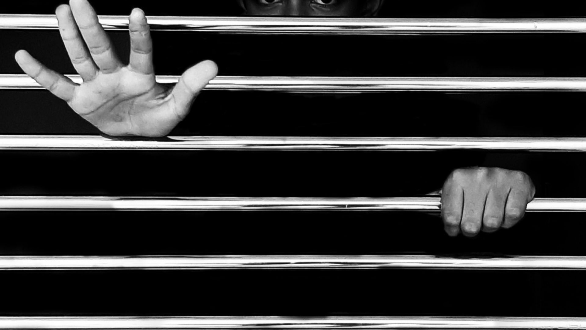 persons hand on black metal frame