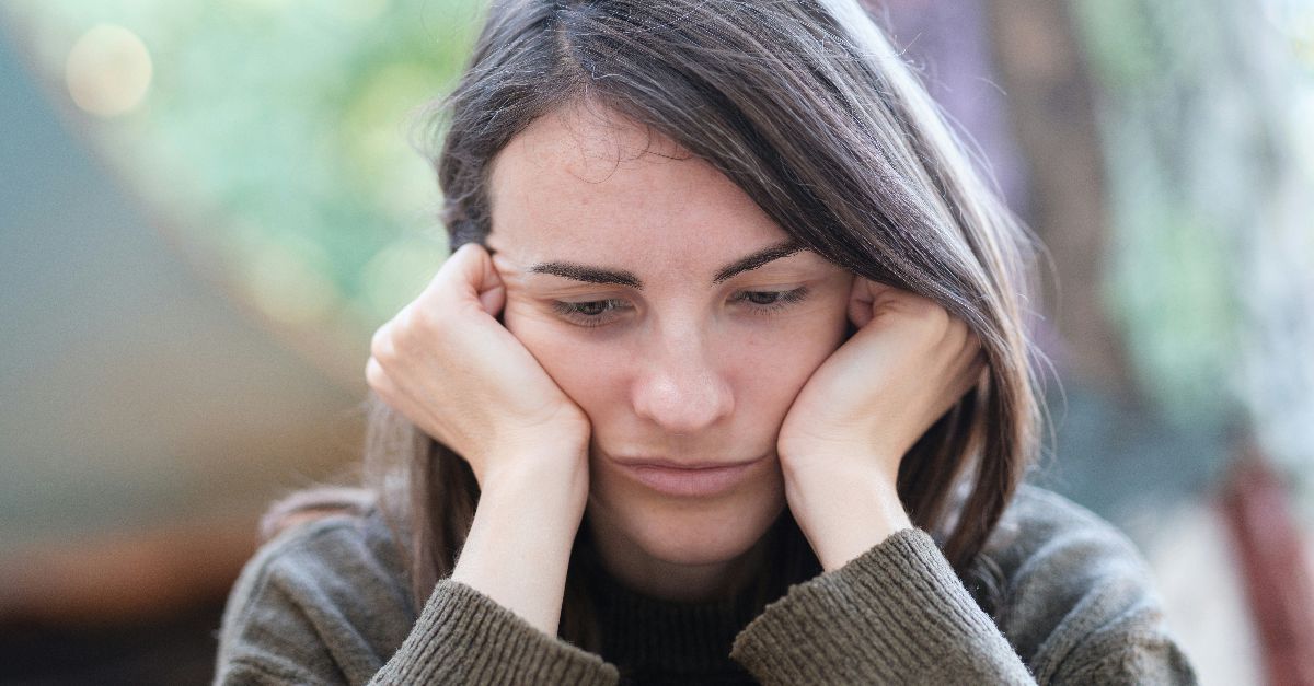 a woman holding her head in her hands