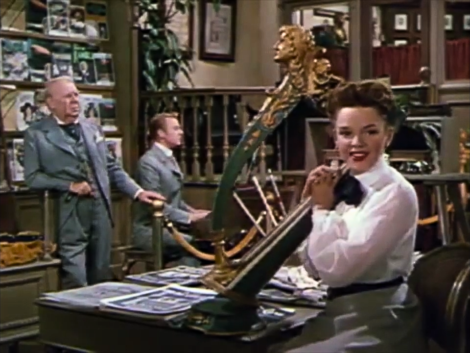 A screenshot of Judy Garland, Van Johnson and S. Z. Sakall from the trailer for In the Good Old Summertime (1949).