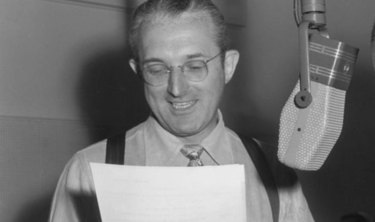 14th August 1947: EXCLUSIVE American musician and band leader Louis Armstrong (1901 - 1971) reads at a microphone with American bandleader Tommy Dorsey (1905 - 1956) on Dorsey's radio show.