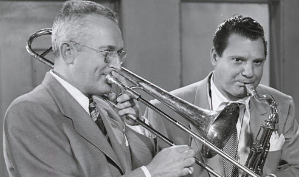 (Original Caption) Tommy Dorsey (L) and Vita Musso (2nd from L) in a scene from the 1952 Allied Artists film, 