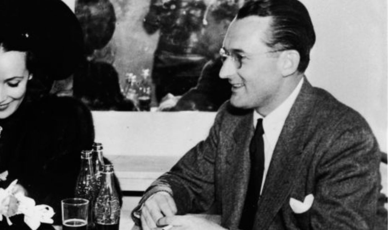 L-R: American actor and director Orson Welles (1915 - 1985) sits at a restaurant table with Mexican-born actor Dolores Del Rio (1905 - 1983) and American jazz trombonist Tommy Dorsey (1905 - 1956), 1930s.