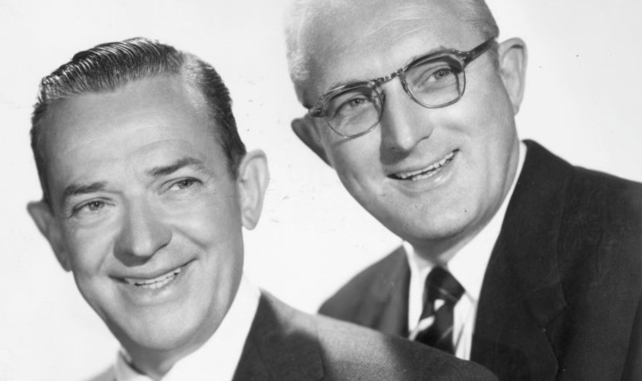 circa 1955: Studio portrait of American jazz bandleaders Jimmy (1904 - 1957)(L) and Tommy Dorsey (1905 - 1956), smiling in front of a white backdrop. 