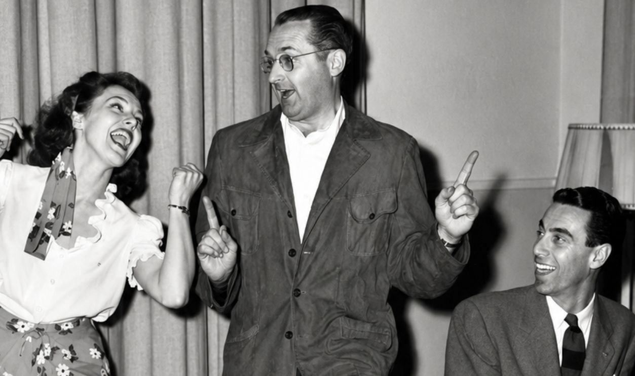 16th October 1944: EXCLUSIVE American jazz bandleader Tommy Dorsey (1905 - 1956) dances with a young woman as a man plays the piano. 